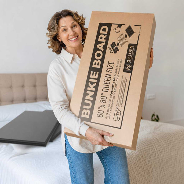 Customer holding Golden Home Essentials queen size 60x80 bunkie board box, package includes 2 pieces