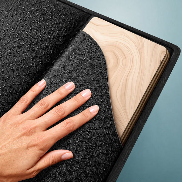 Close-up of couch support board's plywood core and non-slip fabric surface
